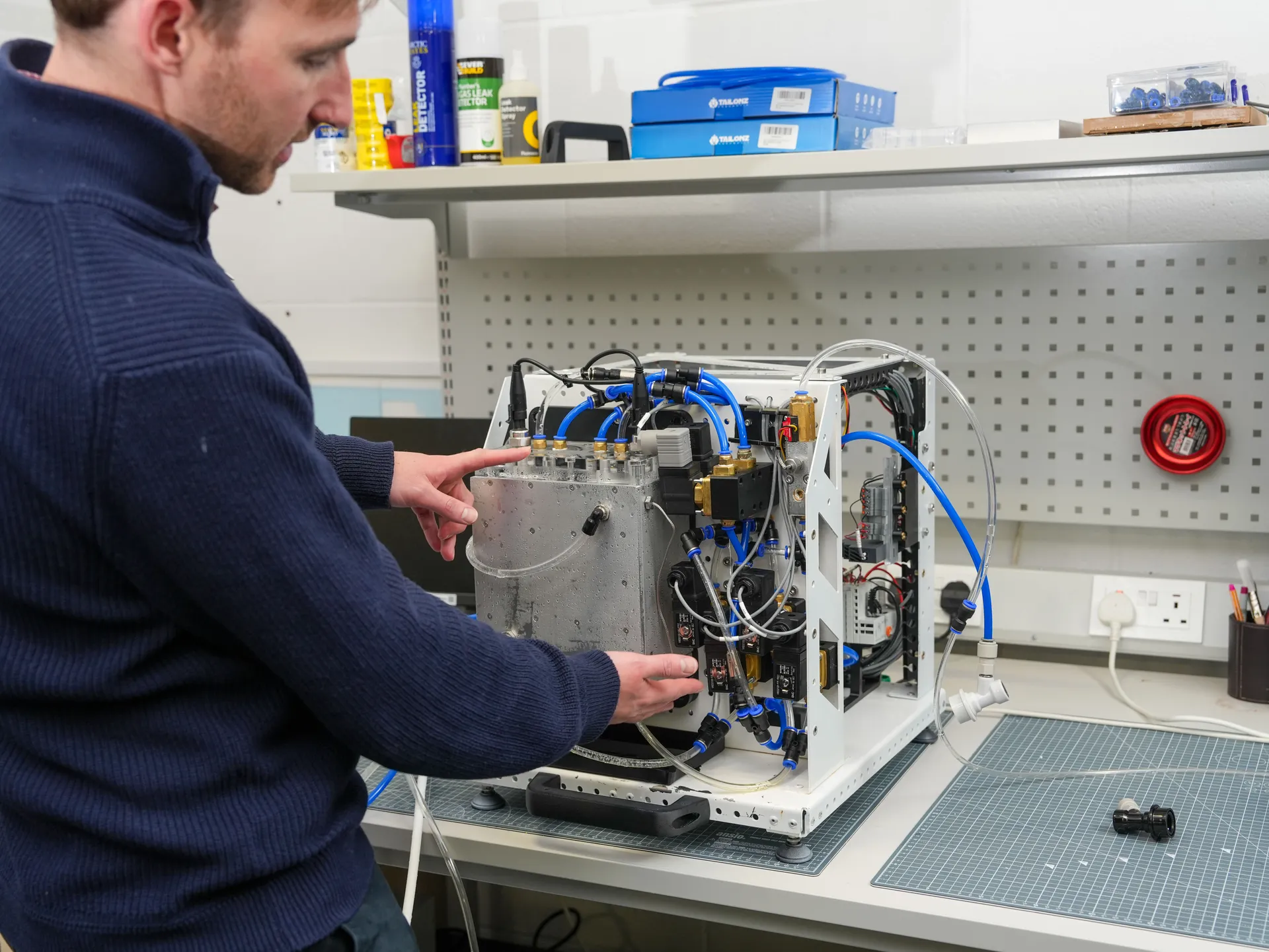 Engineer working on the Pfizics alpha unit